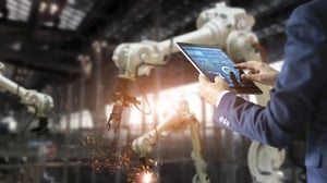 manager-industrial-engineer-using-tablet-check-control-automation-robot-arms-machine